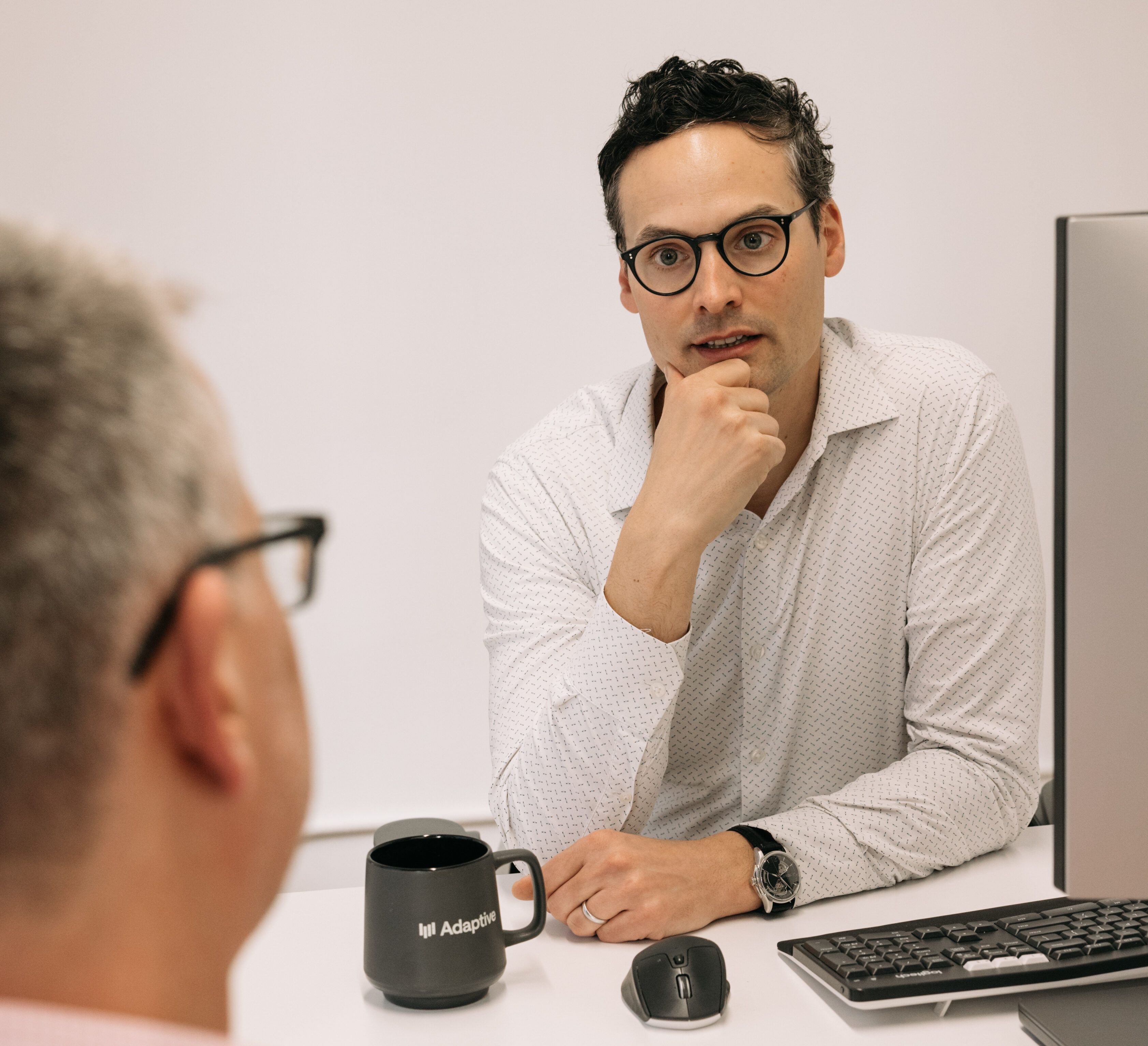 IMental Health and Wellbeing at Work - having safe conversations. One man is listening at another one sitting in front of him